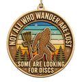 Round Sunset Scene Shows A Sasquatch Beside A Chained Basket And Pine Trees. Funny Gift For Disc Golf And Cryptid Fans.