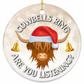 Shaggy Highland Cow in a Santa Hat With a Gold Bell Hanging From Each Horn. Ceramic Keepsake for Cow Lovers.